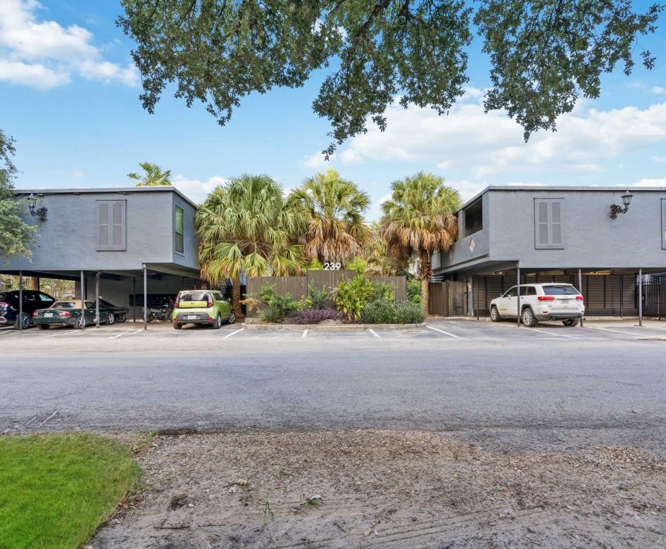 a parking lot with cars and trees