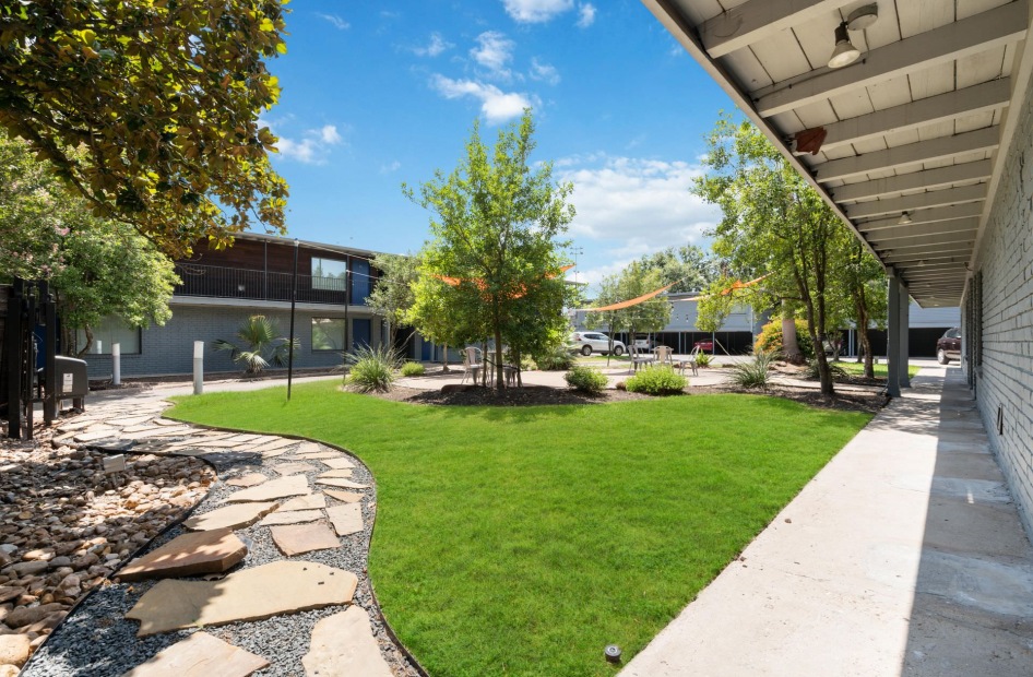 courtyard with green grass and trees