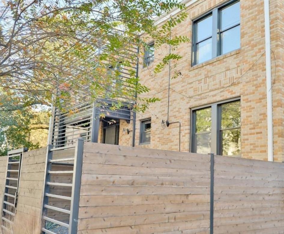 a brick building with a fence around it