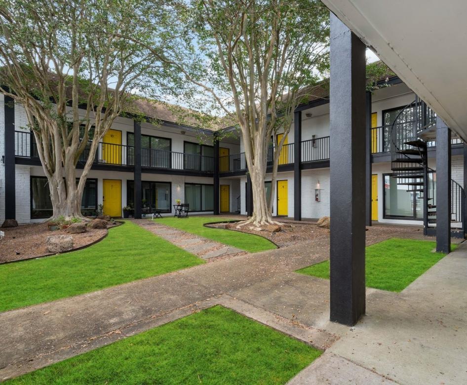 a building with a walkway and grass